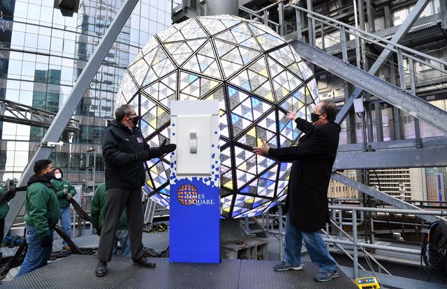 Tom Harris of the TImes Square Alliance and Jeffrey Strauss of Countdown Entertainment demonstrate the New Year's Eve Ball's illumination, with Strauss exclaiming after lighting the ball